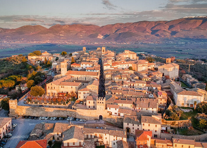 Golden hour light over a hilltop village in the Tuscany Umbria Marche border region