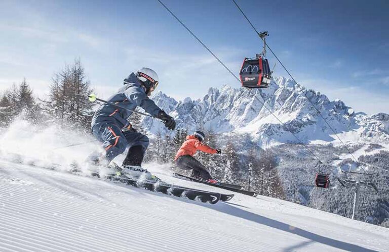 Skiers descending slopes in the Dolomites