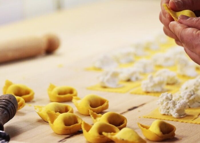 Hands shaping fresh pasta, highlighting Italian culinary craftsmanship