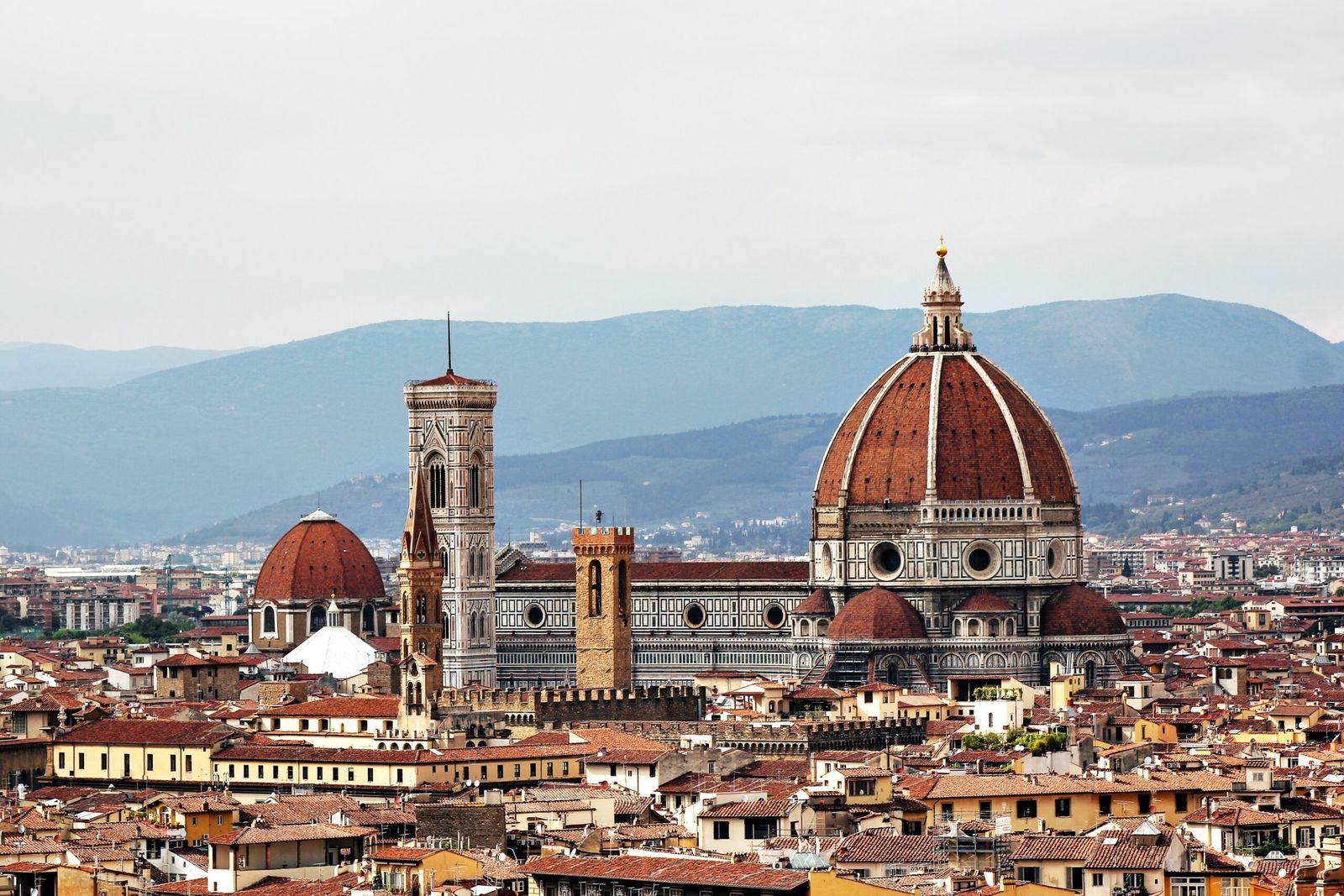 Brunelleschi’s dome and Giotto’s bell tower rising above the rooftops of Florence, hills beyond