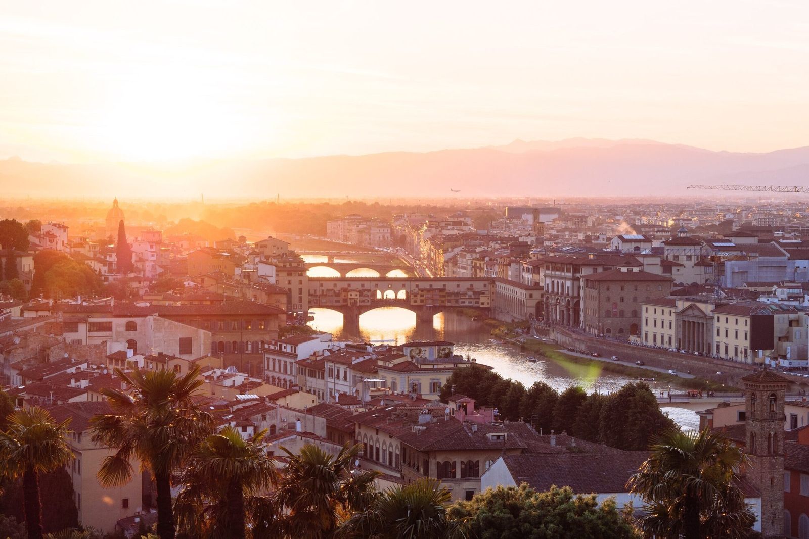 Florence at sunset, the Ponte Vecchio spanning the Arno among terracotta rooftops