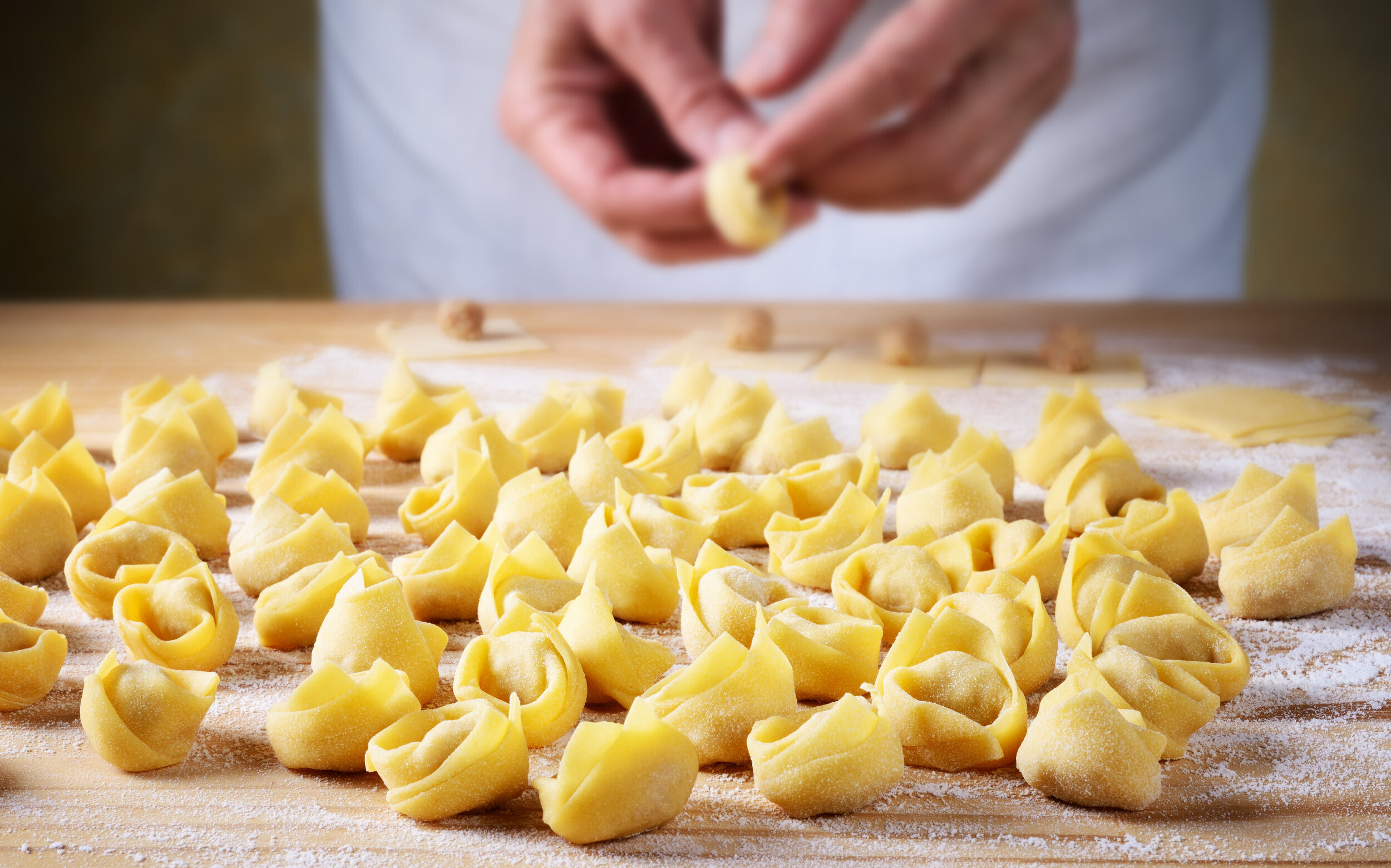 Zwei Pastamacherinnen, die von Hand Tortellini formen